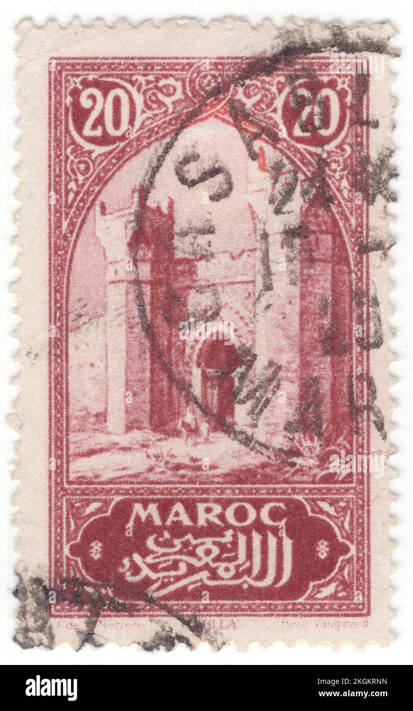 FRENCH MOROCCO - 1917: An 20 centimes red-brown postage stamp depicting City Gate Chella, Morocco landmark. The Chellah or Shalla is a medieval fortified Muslim necropolis and ancient archeological site in Rabat, Morocco, located on the south Bou Regreg estuary. The earliest evidence of the site's occupation suggests that the Phoenicians established a trading emporium here in the first millennium BC. This was later the site of Sala Colonia, an ancient Roman colony in the province of Mauretania Tingitana, before it was abandoned in Late Antiquity Stock Photo