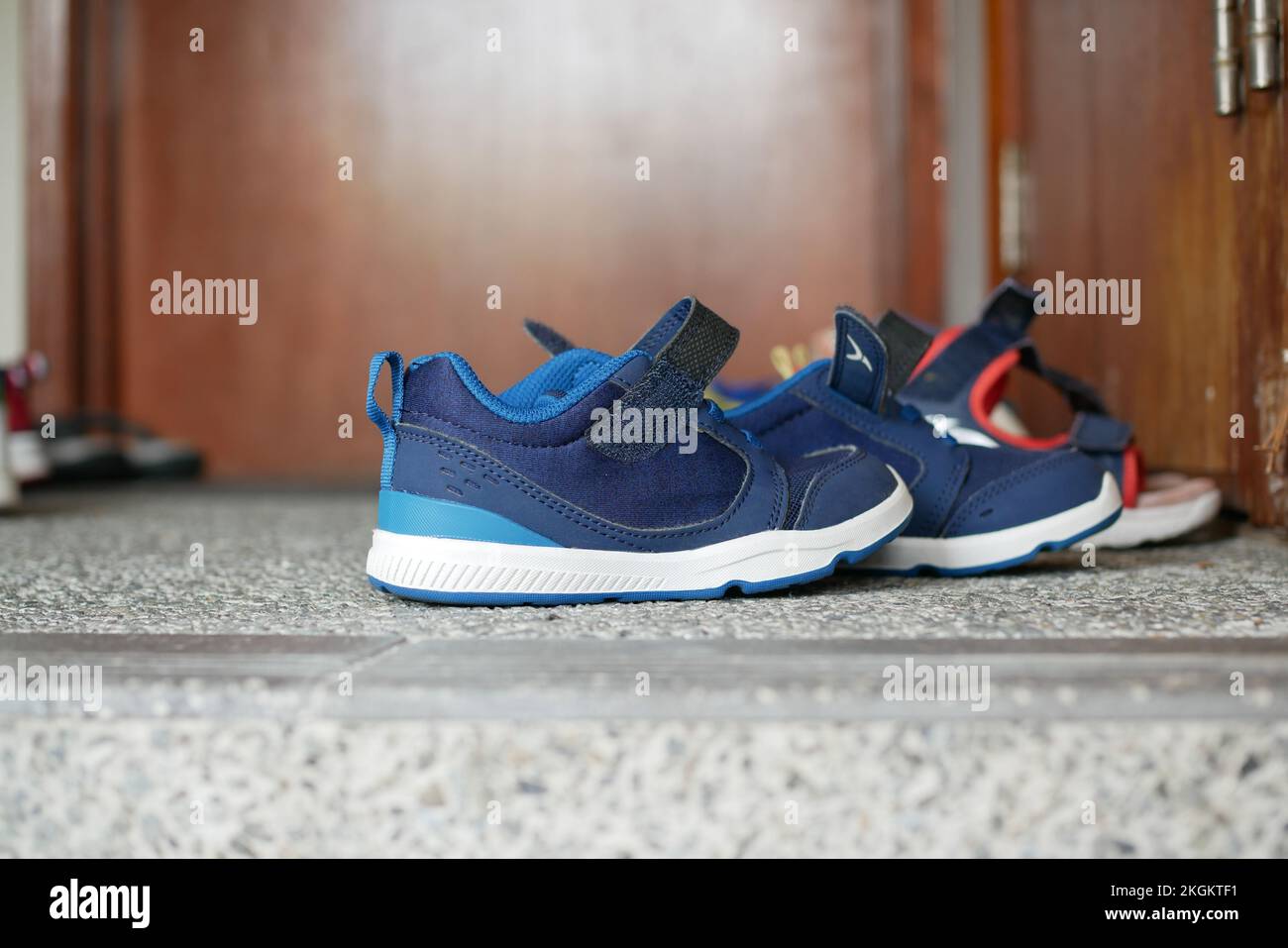 children's shoes in front of door Stock Photo Alamy