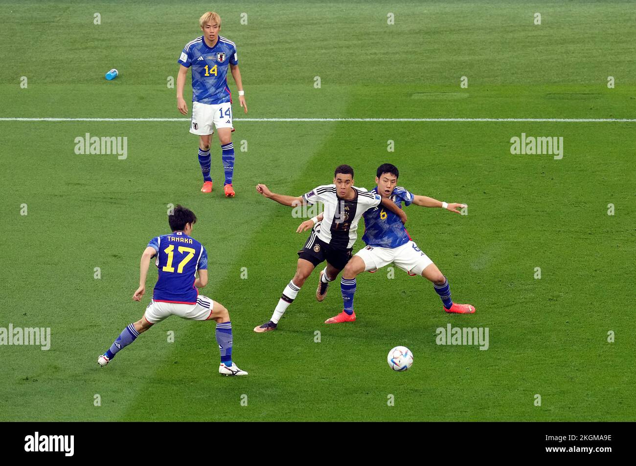 Germany’s Jamal Musiala and Japan’s Wataru Endo (right) battle for the ball during the FIFA World Cup Group E match at the Khalifa International Stadium, Doha, Qatar. Picture date: Wednesday November 23, 2022. Stock Photo