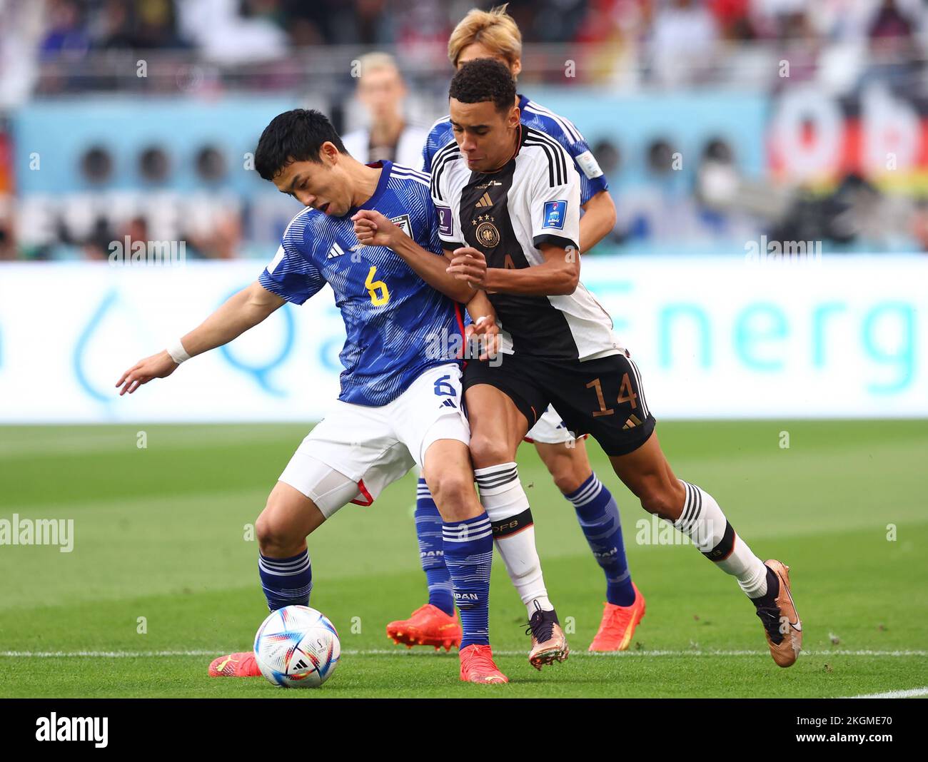 Doha, Qatar, 23rd November 2022.  Wataru Endo of Japan tussles with Jamal Musiala of Germany during the FIFA World Cup 2022 match at Khalifa International Stadium, Doha. Picture credit should read: David Klein / Sportimage Credit: Sportimage/Alamy Live News Stock Photo