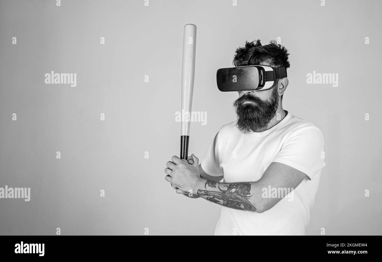 Man with long beard concentrated on virtual reality game. Bearded man