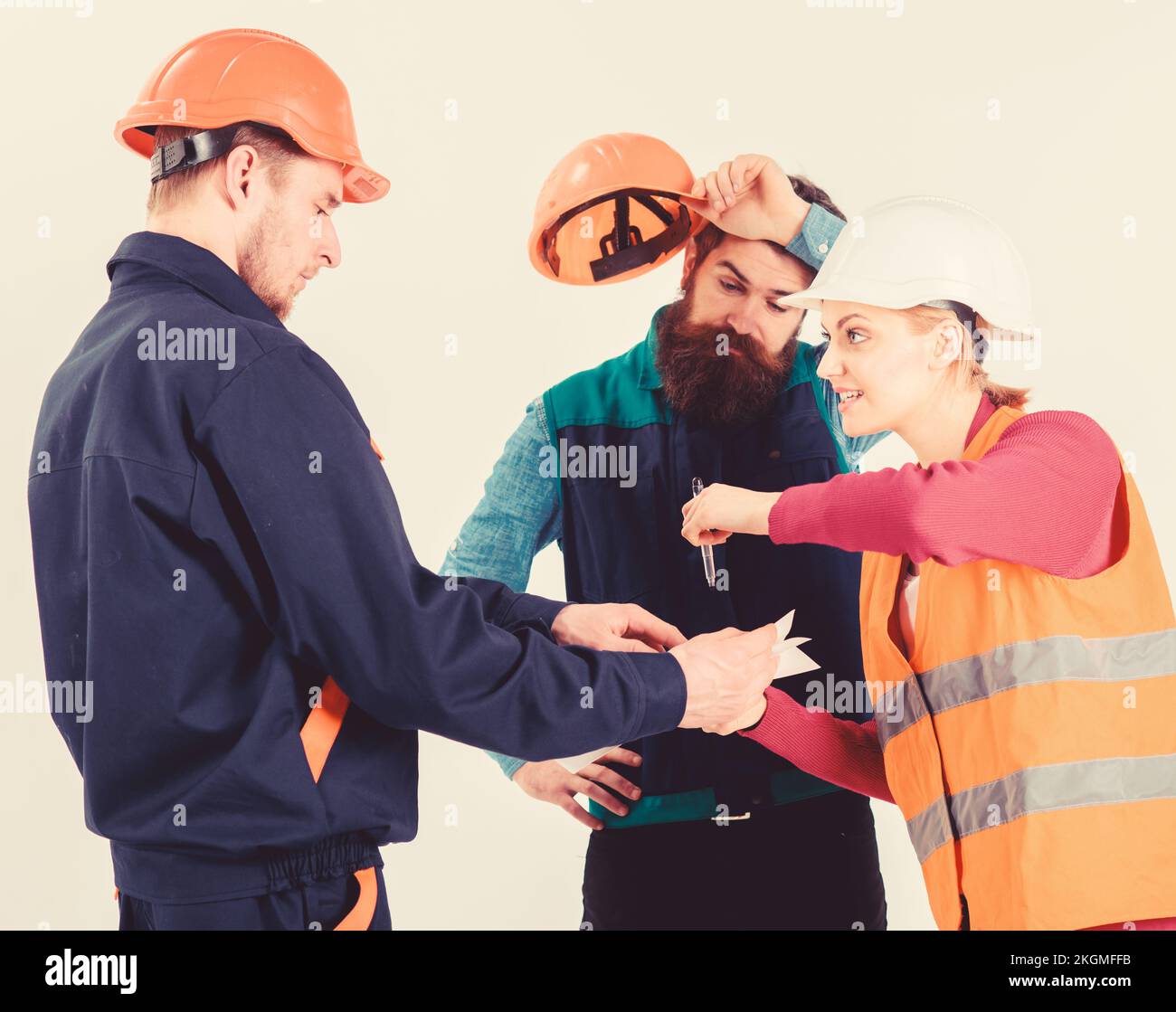 Men in hard hats and uniform and young woman Stock Photo - Alamy