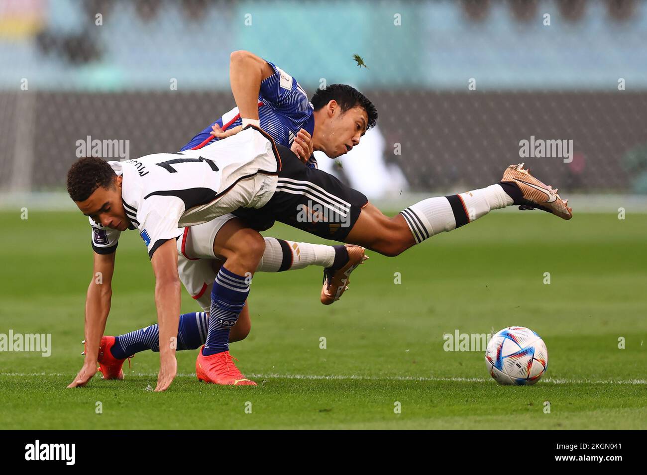 Doha, Qatar, 23rd November 2022. Jamal Musiala of Germany tackled by Wataru Endo of Japan during the FIFA World Cup 2022 match at Khalifa International Stadium, Doha. Picture credit should read: David Klein / Sportimage Credit: Sportimage/Alamy Live News Stock Photo