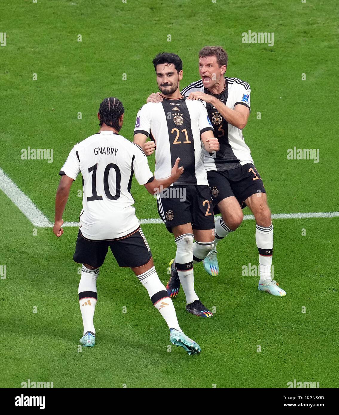 Germany’s Ilkay Gundogan (centre) celebrates scoring their side's first goal of the game with team-mates Serge Gnabry and Thomas Muller during the FIFA World Cup Group E match at the Khalifa International Stadium, Doha, Qatar. Picture date: Wednesday November 23, 2022. Stock Photo