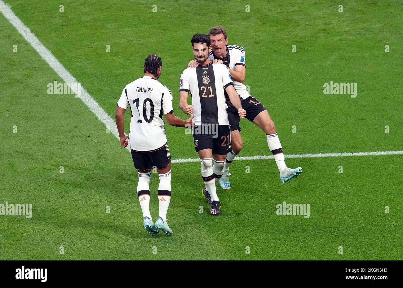 Germany’s Ilkay Gundogan (centre) celebrates scoring their side's first goal of the game with team-mates Serge Gnabry and Thomas Muller during the FIFA World Cup Group E match at the Khalifa International Stadium, Doha, Qatar. Picture date: Wednesday November 23, 2022. Stock Photo