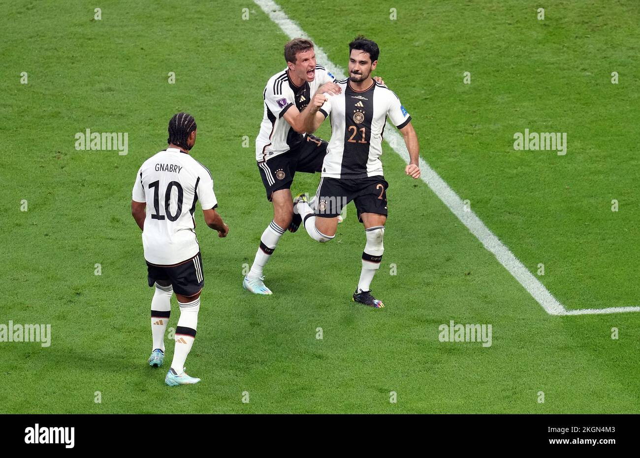 Germany’s Ilkay Gundogan (right) celebrates scoring their side's first goal of the game with team-mates Serge Gnabry and Thomas Muller during the FIFA World Cup Group E match at the Khalifa International Stadium, Doha, Qatar. Picture date: Wednesday November 23, 2022. Stock Photo