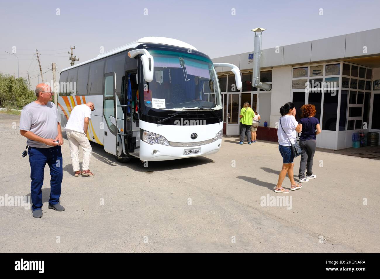 Uzbekistan tourists tour bus stops at a small service station between