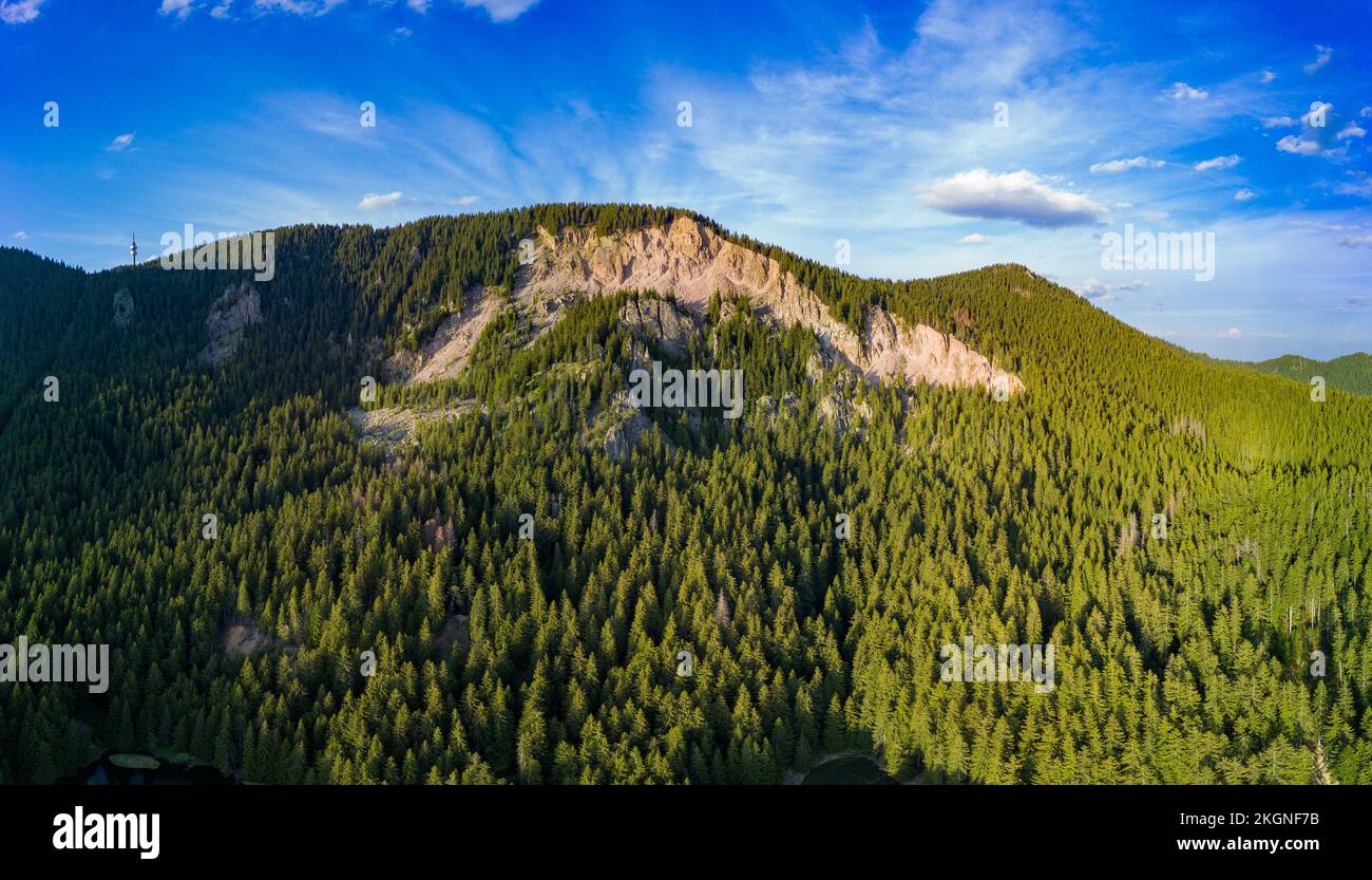 Peak of Rhodope mountain with forests against background of clouds. Panorama, top view Stock Photo