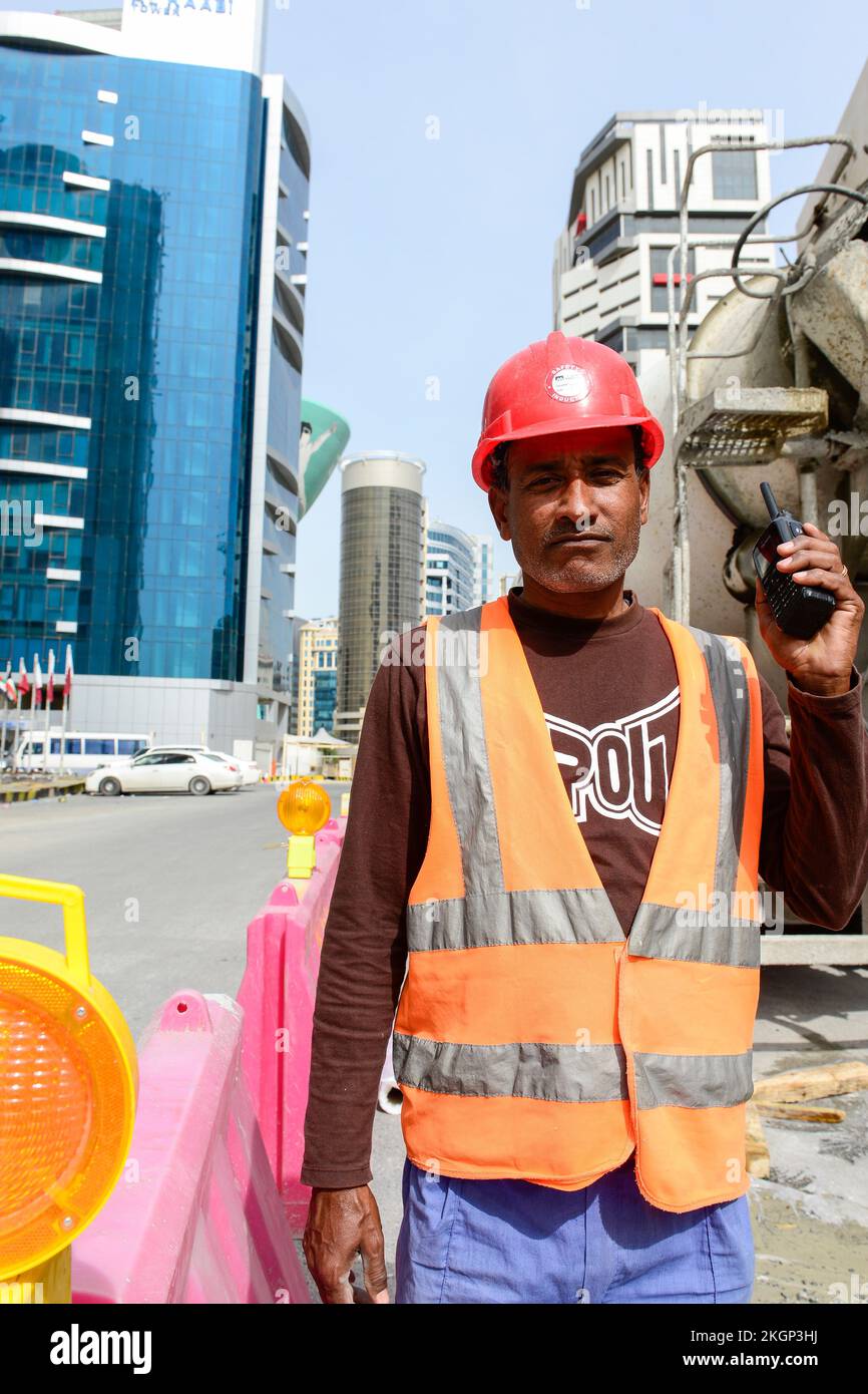 QATAR, Doha, construction boom for FIFA football world cup 2022 , the construction is done by migrant workers from all over the world / KATAR, Doha, Bauboom fuer die FIFA Fußball WM 2022/ KATAR, Doha, Bauboom fuer die FIFA Fußball WM 2022, auf den Baustellen schuften Gastarbeiter aus aller Welt Stock Photo