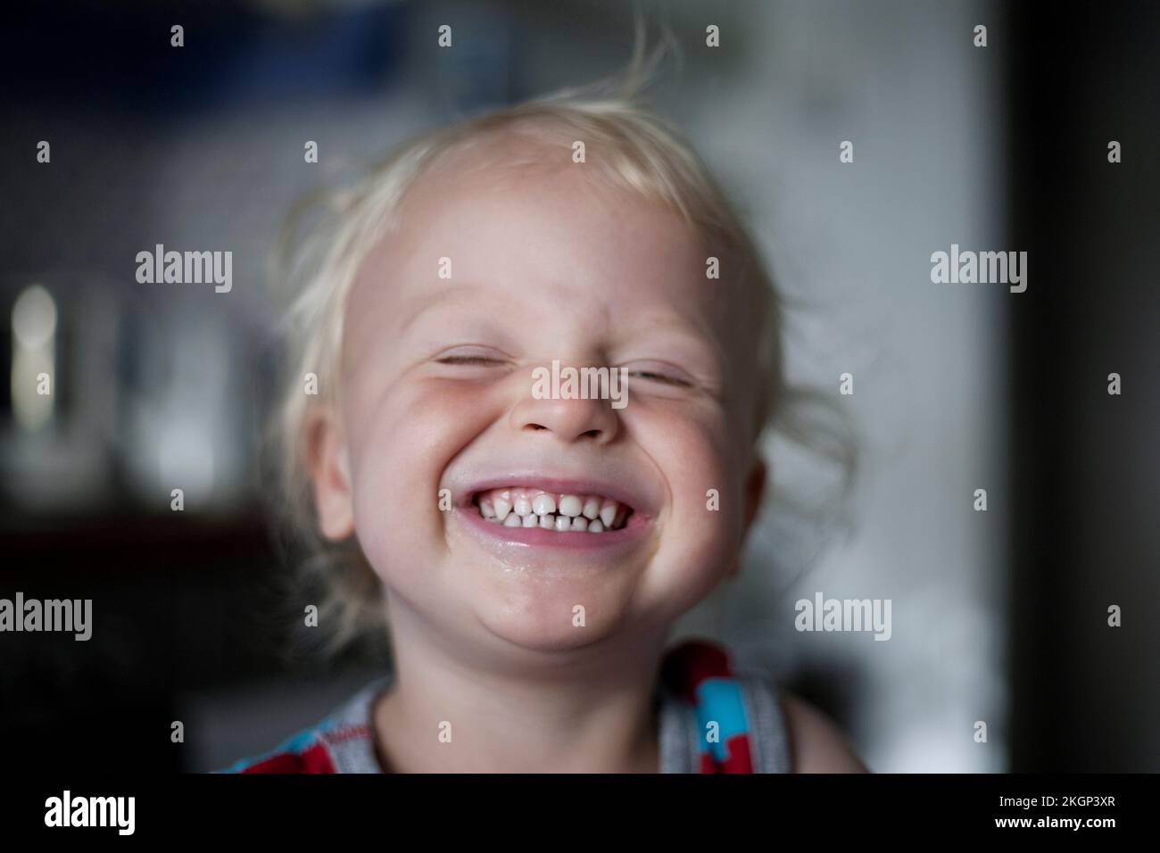 Portrait of laughing little boy with closed eyes Stock Photo