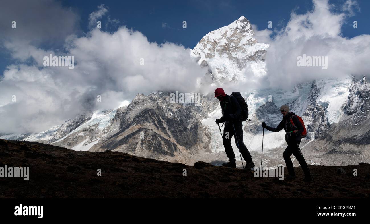 Man and woman trekking with Mt Everest, Nuptse and Kala Patthar in background, Himalayas, Solo Khumbu, Nepal Stock Photo