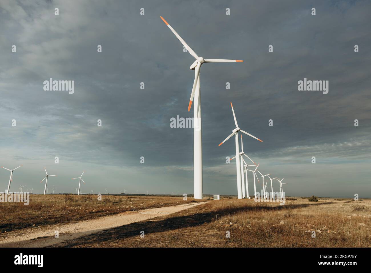 Wind turbines under cloudy sky Stock Photo - Alamy