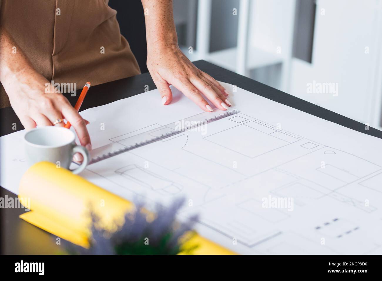 Hands of architect working on blueprint in office Stock Photo