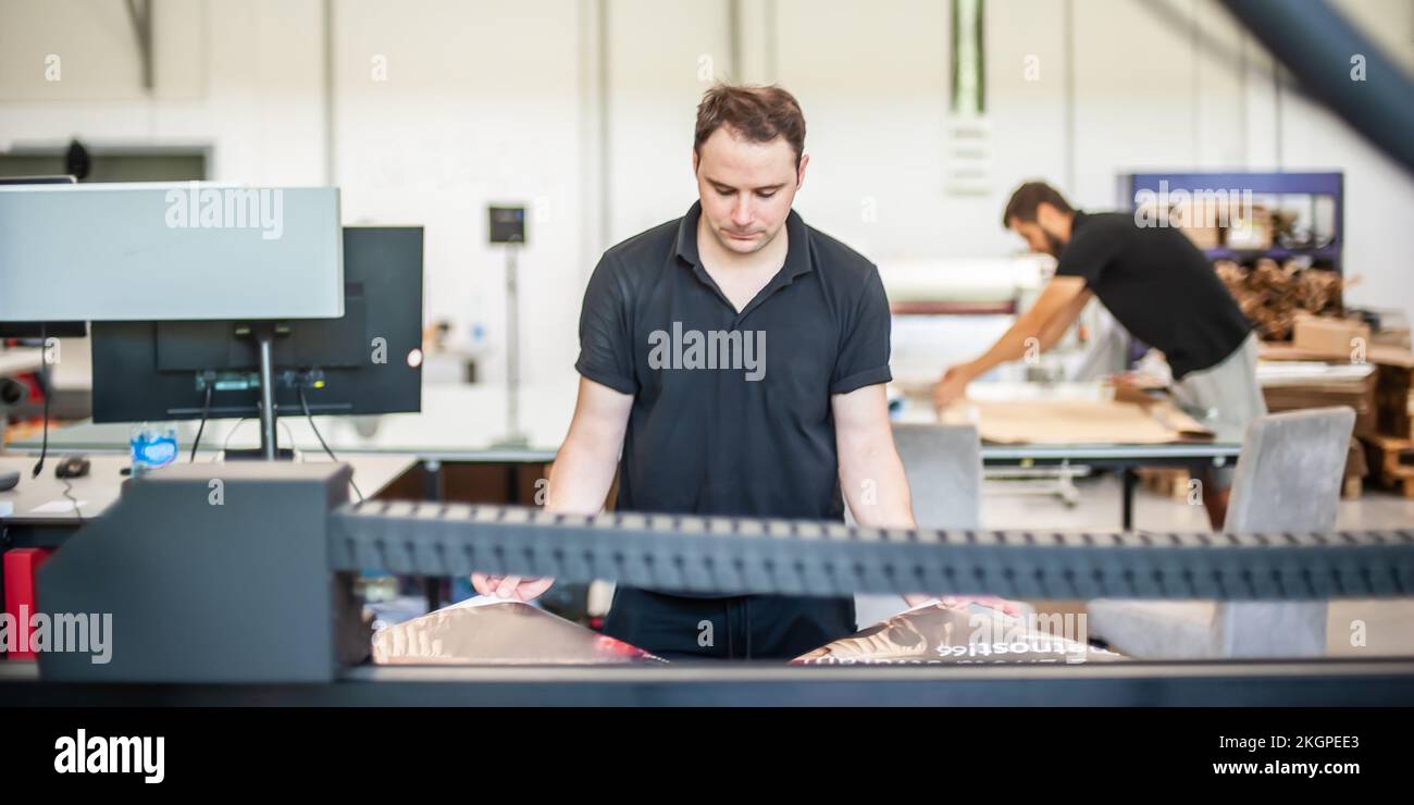 Professional worker printmaker technician operator works in printing