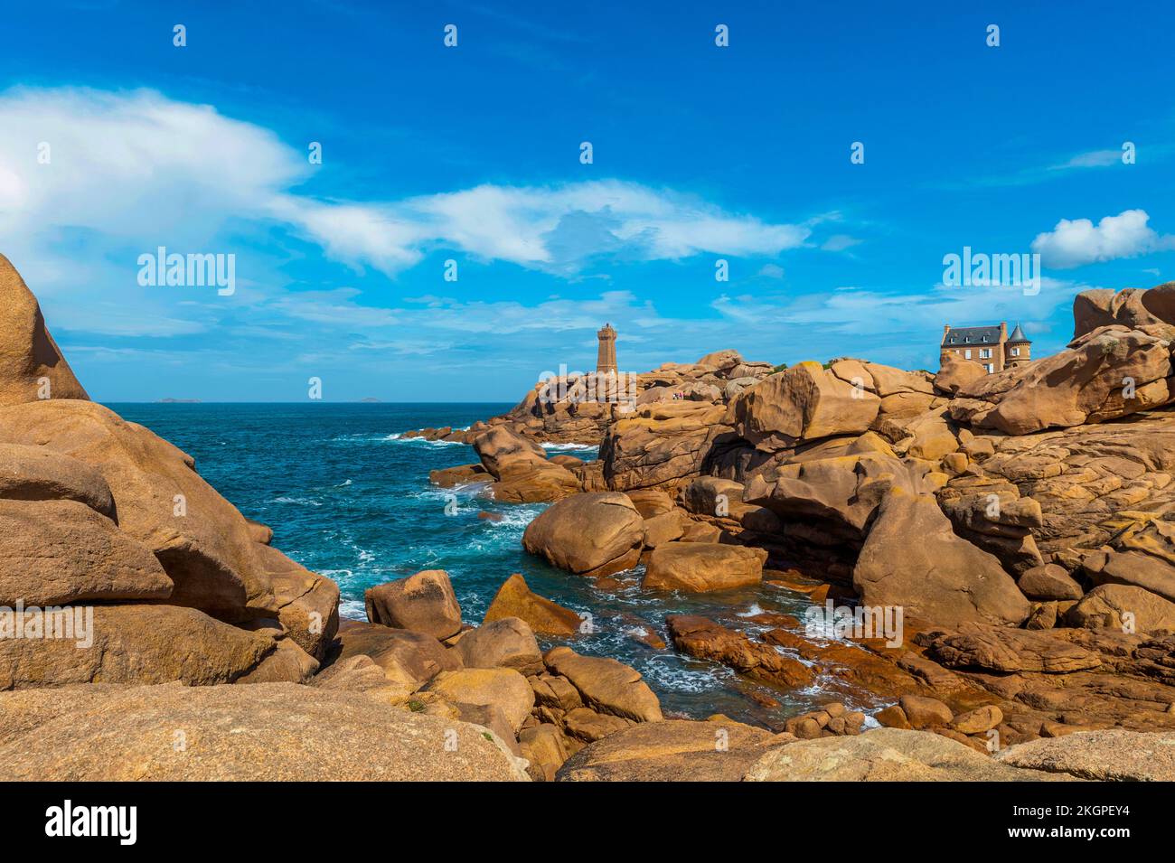 France, Brittany, Cotes-dArmor, Cote de Granit Rose with Ploumanach Lighthouse in background Stock Photo
