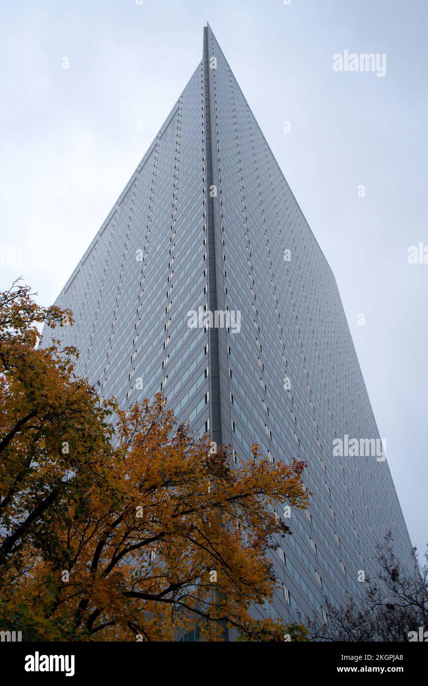 Vertical ground level view of high modern building from corner near ...