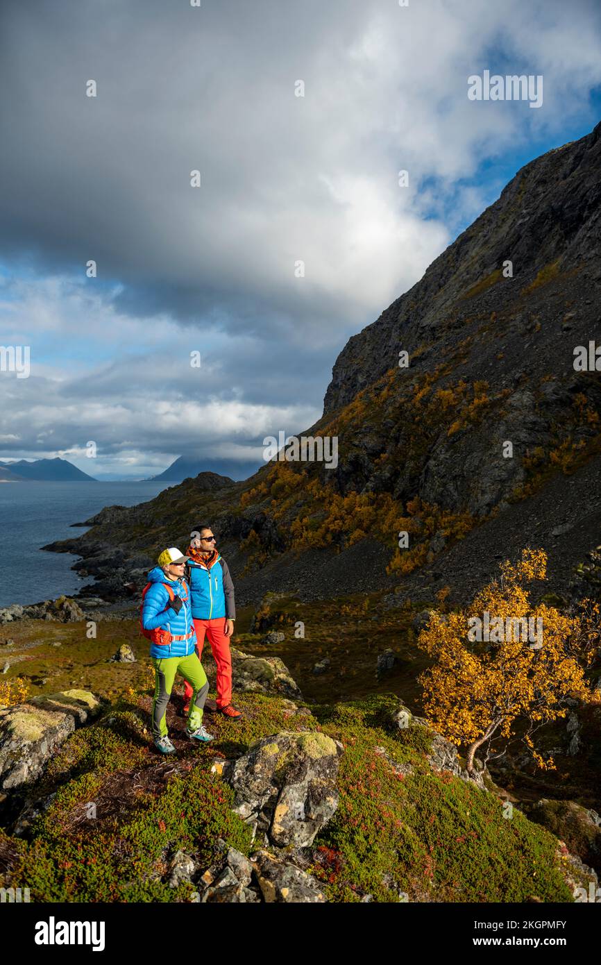 Man and woman standing together on top of mountain Stock Photo - Alamy