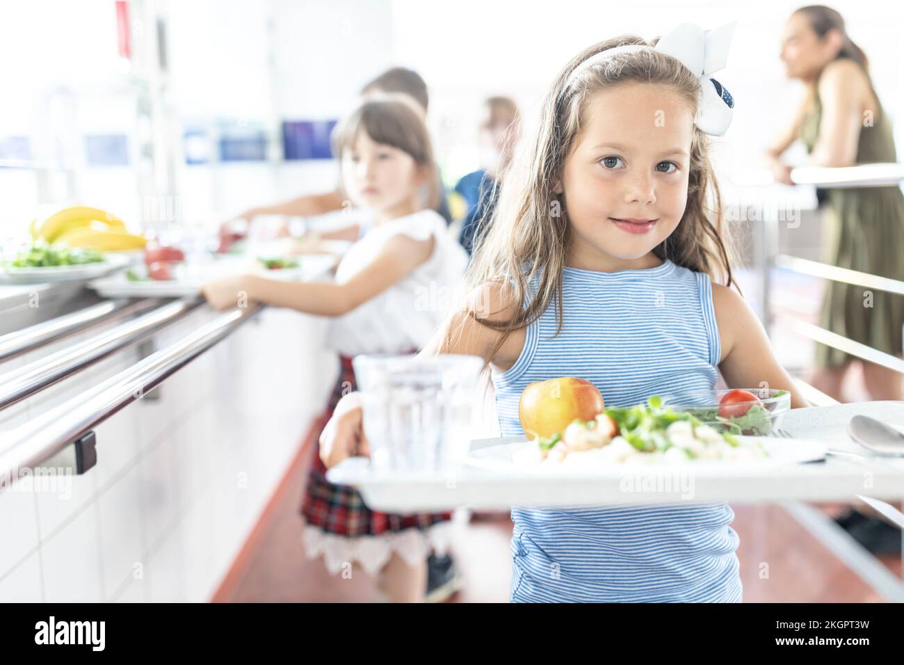 Girl with lunch on tray at lunch break in school cafeteria Stock Photo