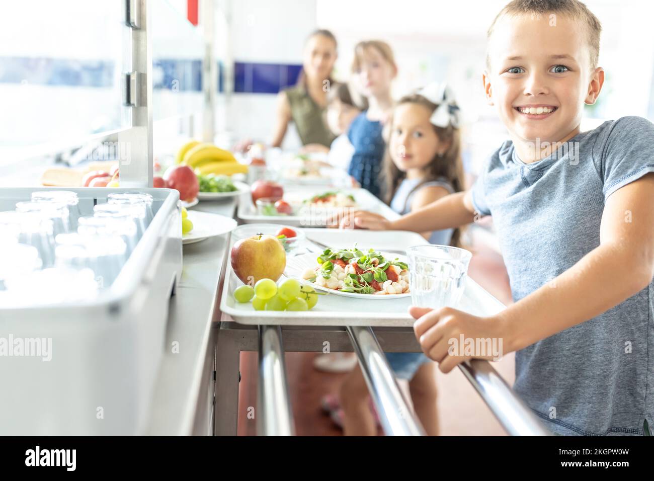 Happy schoolboy with healthy meal at lunch break Stock Photo