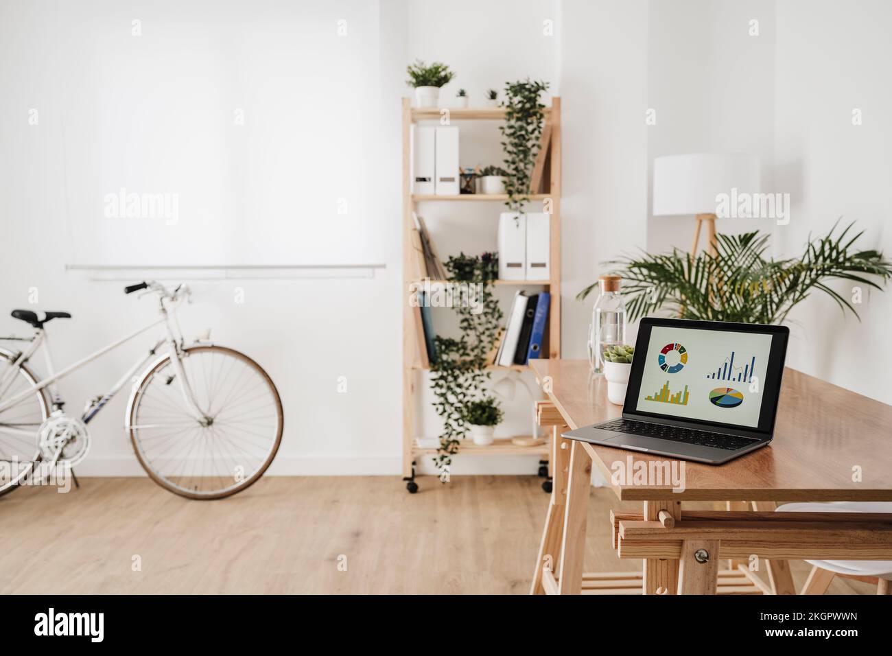Laptop with graphs and chart on device screen at desk in office Stock ...