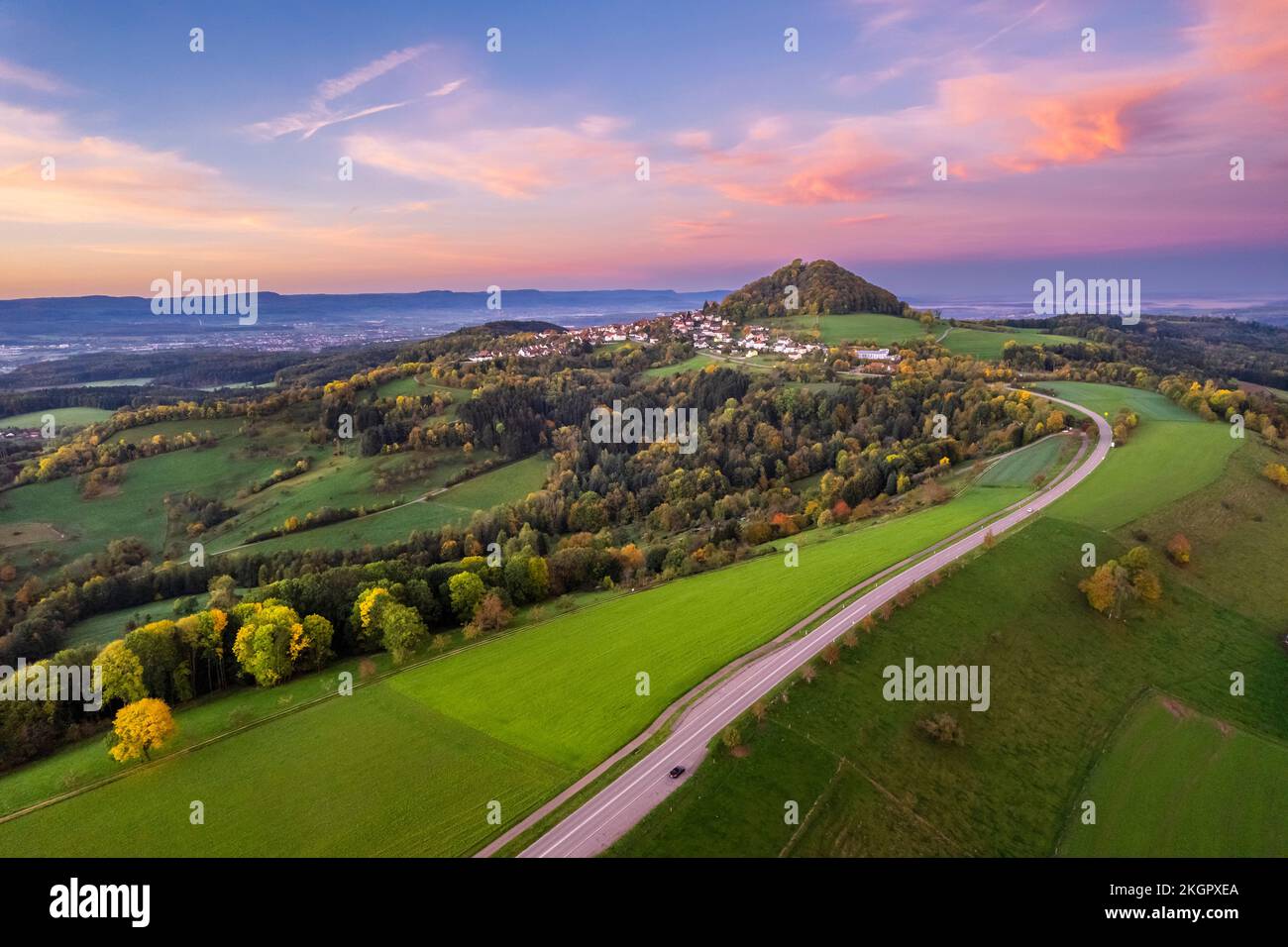 Germany, Baden-Wurttemberg, Drone view of country road stretching toward Hohenstaufen mountain Stock Photo