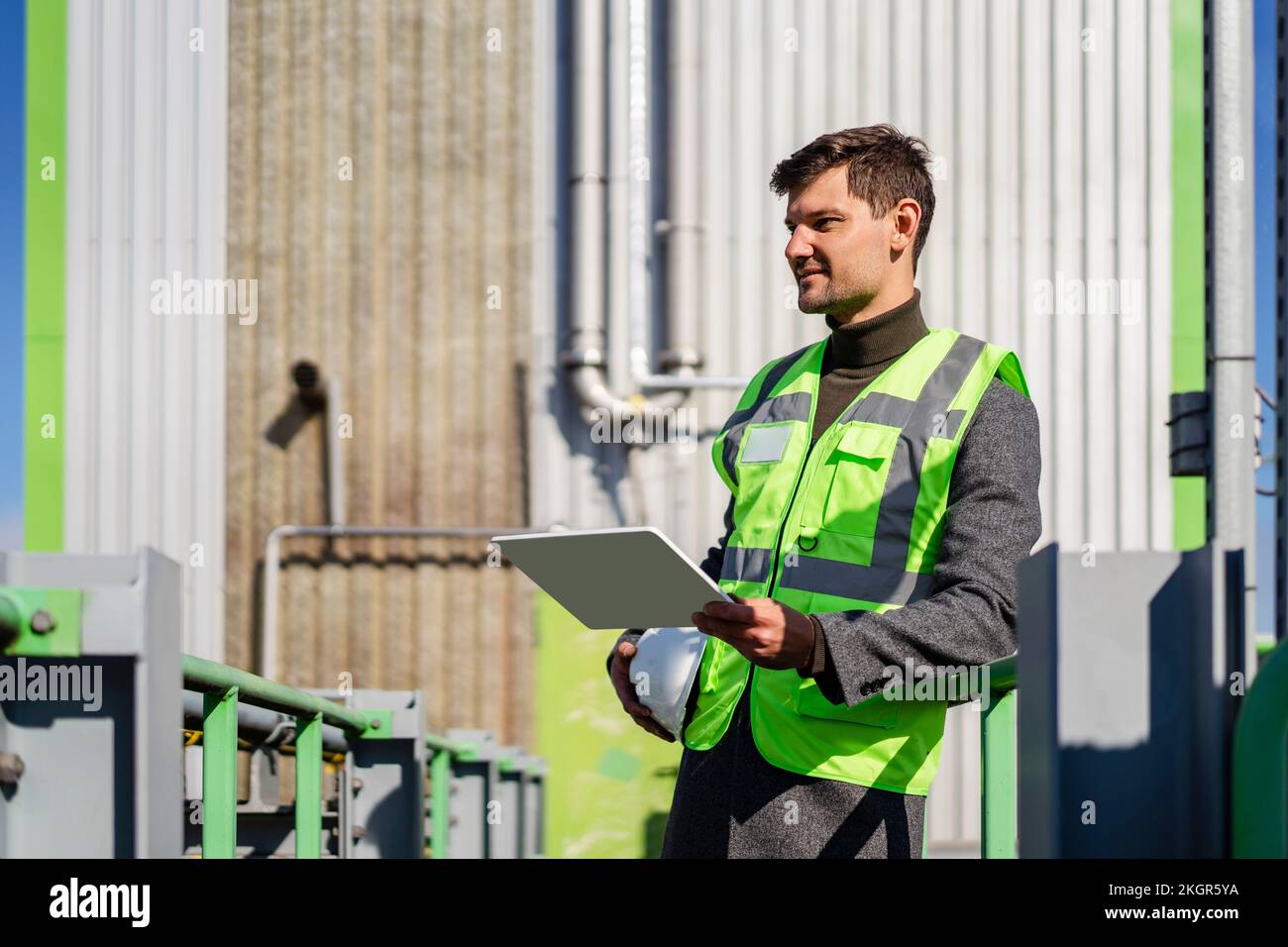 Engineer with tablet PC standing on sunny day Stock Photo
