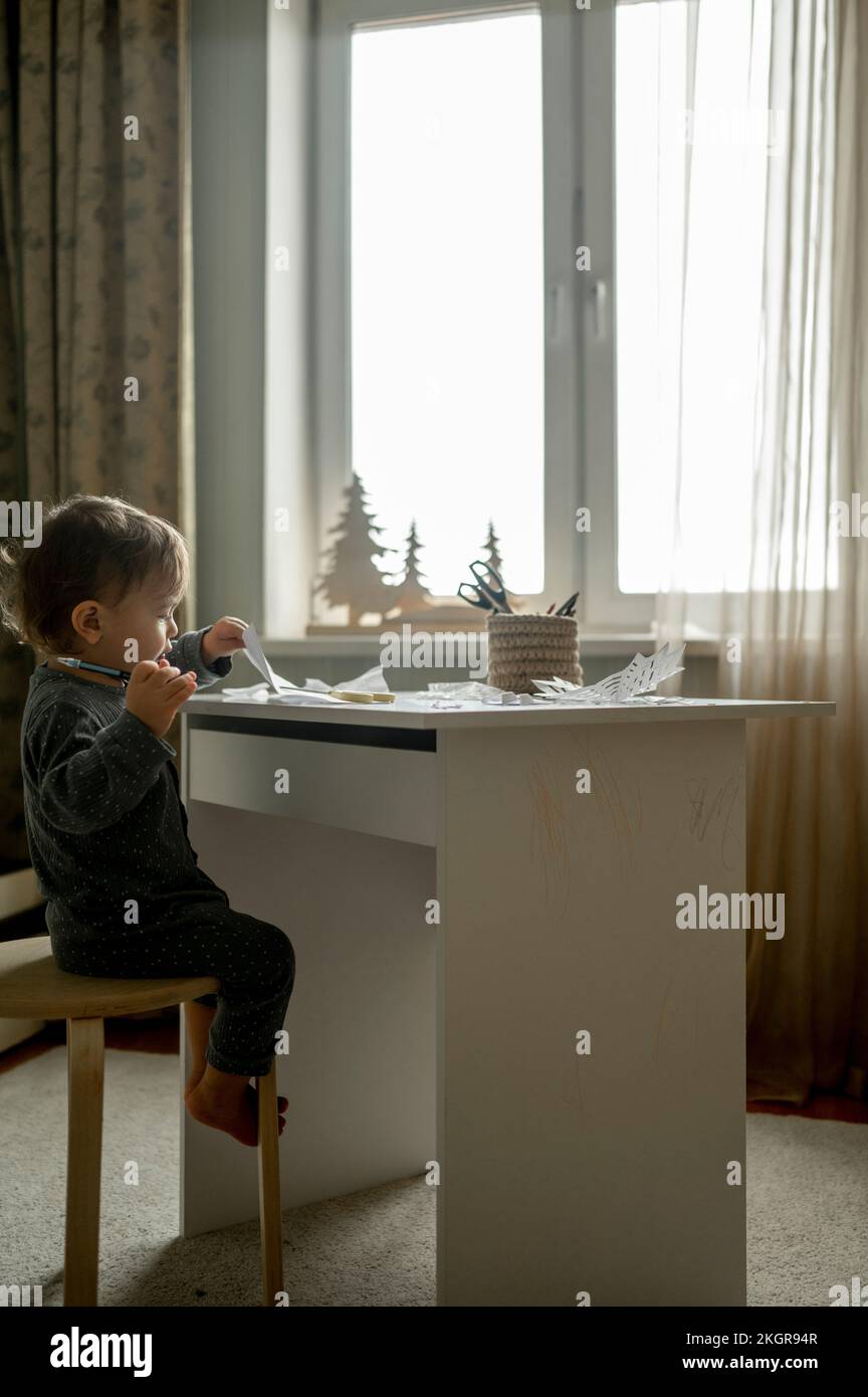 Boy sitting on stool hi-res stock photography and images - Alamy