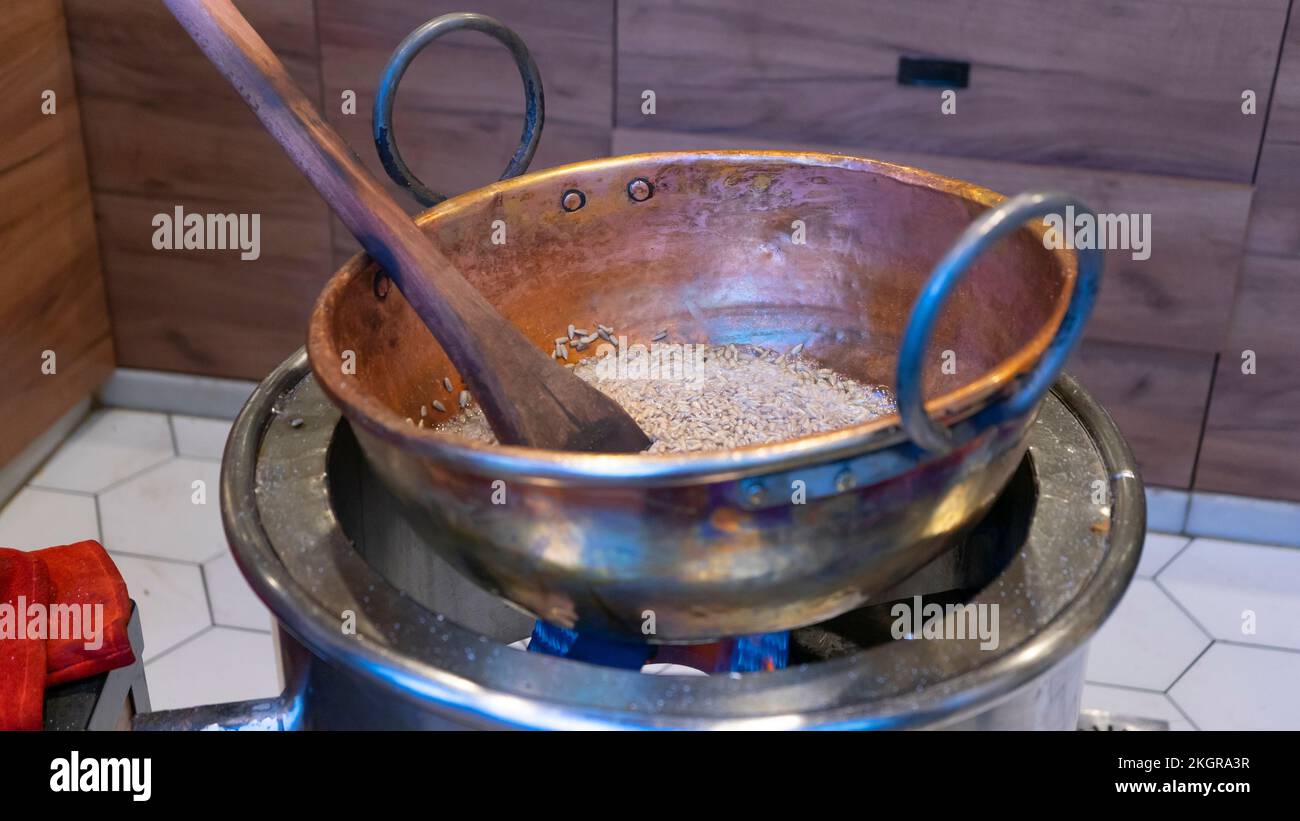The process of making caramelized sunflower seeds in a saucepan Stock