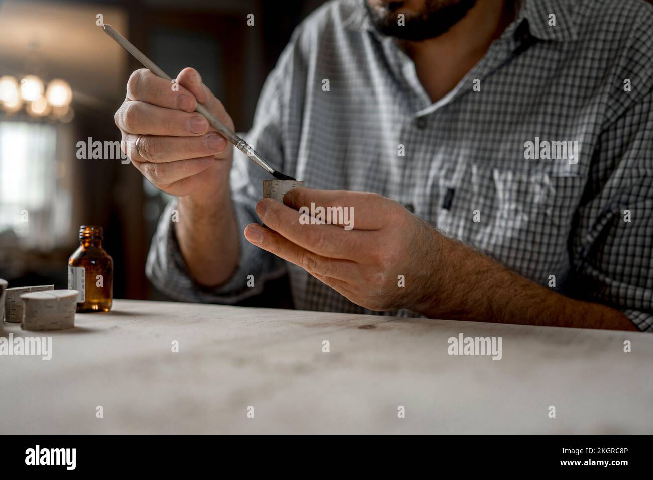 Craftsman brushing oil on wooden blanks Stock Photo Alamy