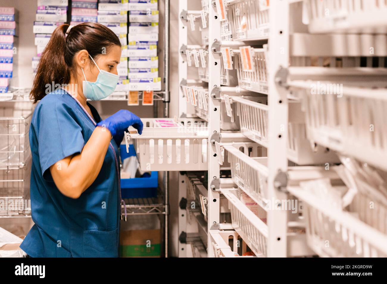 Nurse wearing protective face mask checking inventory at hospital Stock ...