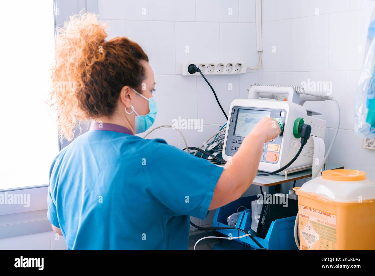 Nurse operating medical equipment at hospital Stock Photo Alamy