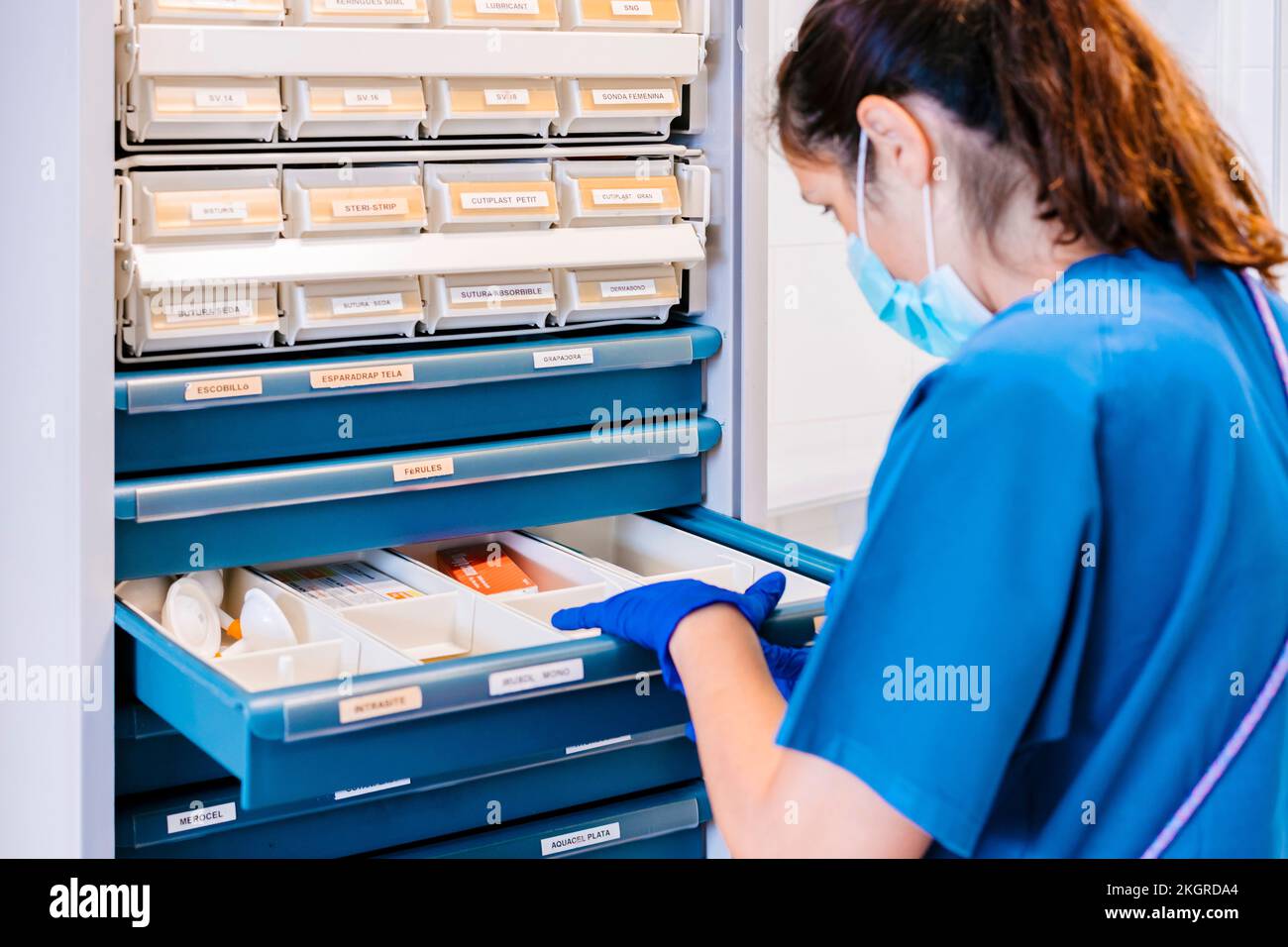 Nurse wearing protective face mask taking inventory at hospital Stock ...
