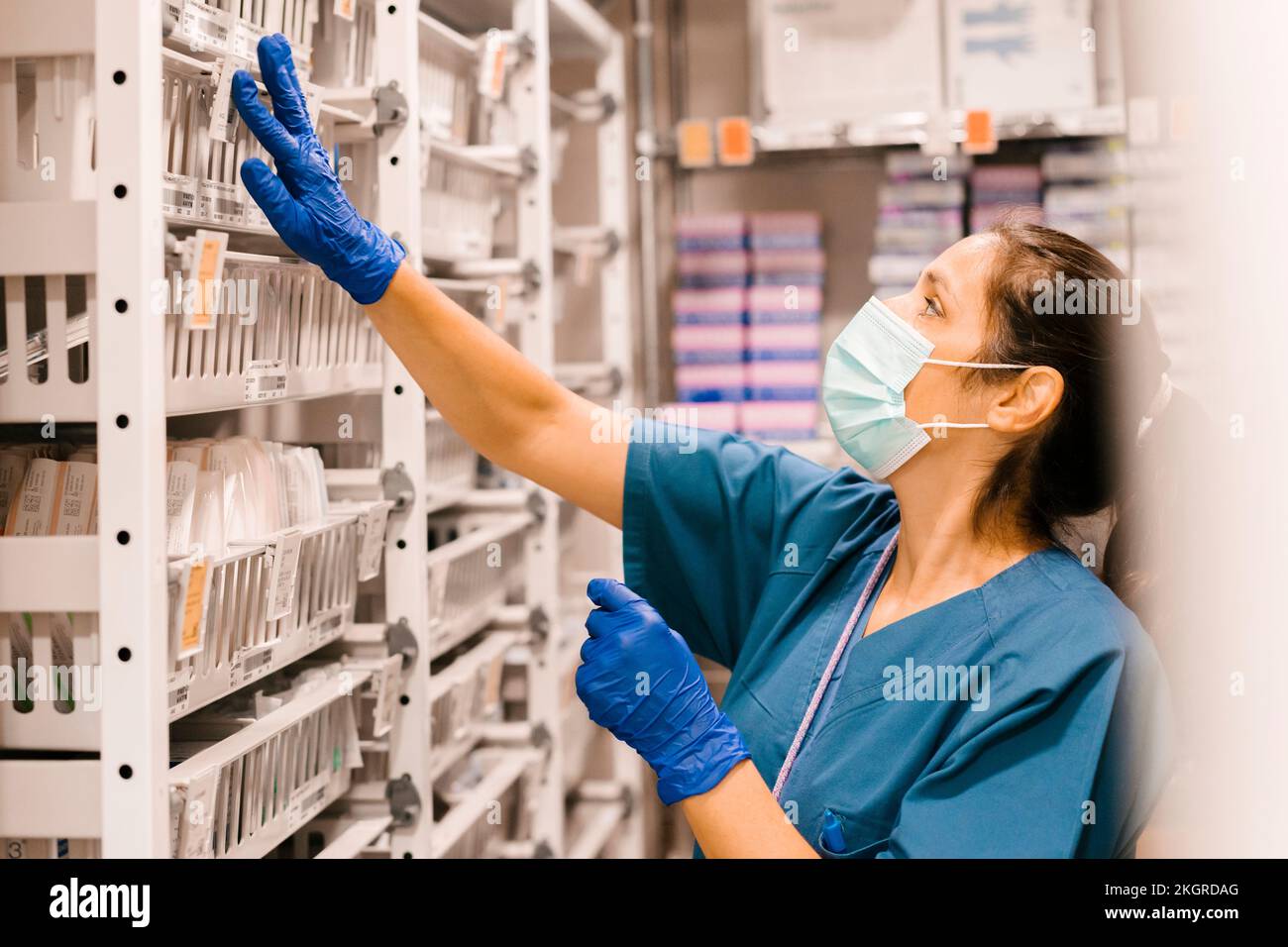 Nurse wearing face mask checking inventory at hospital Stock Photo - Alamy