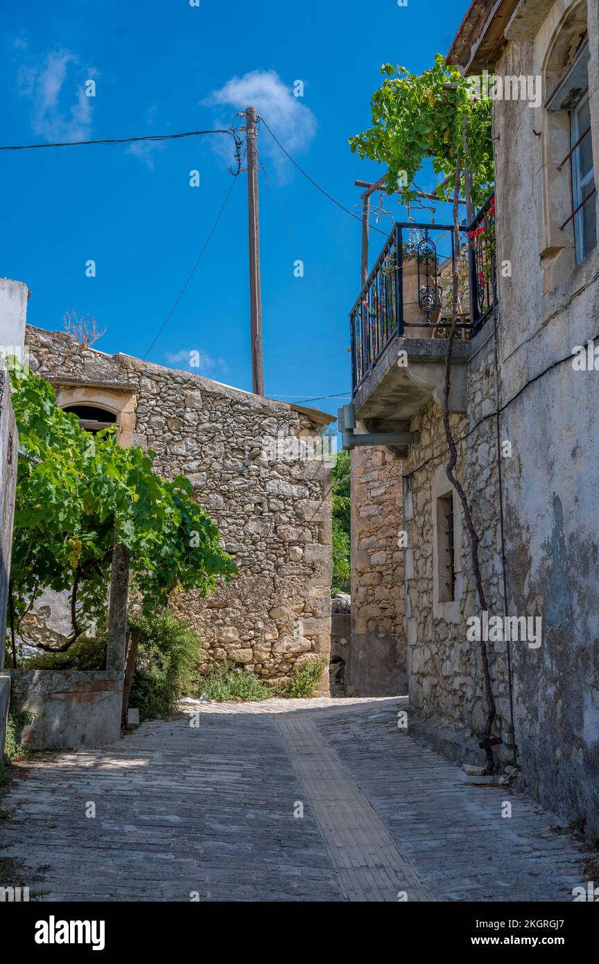 Empty alley with buildings under blue sky Stock Photo