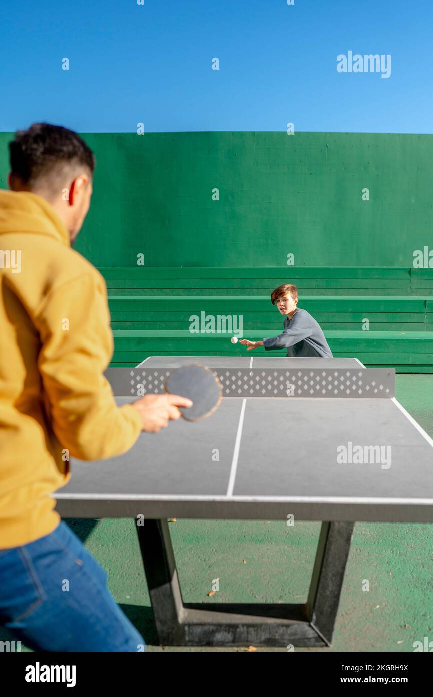 Father and son playing table tennis Stock Photo