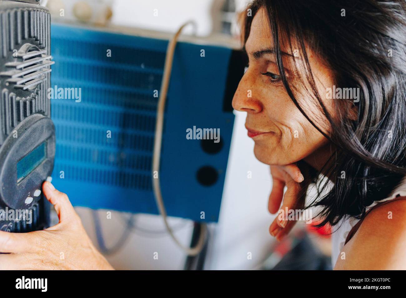 Mature woman using solar inverter Stock Photo