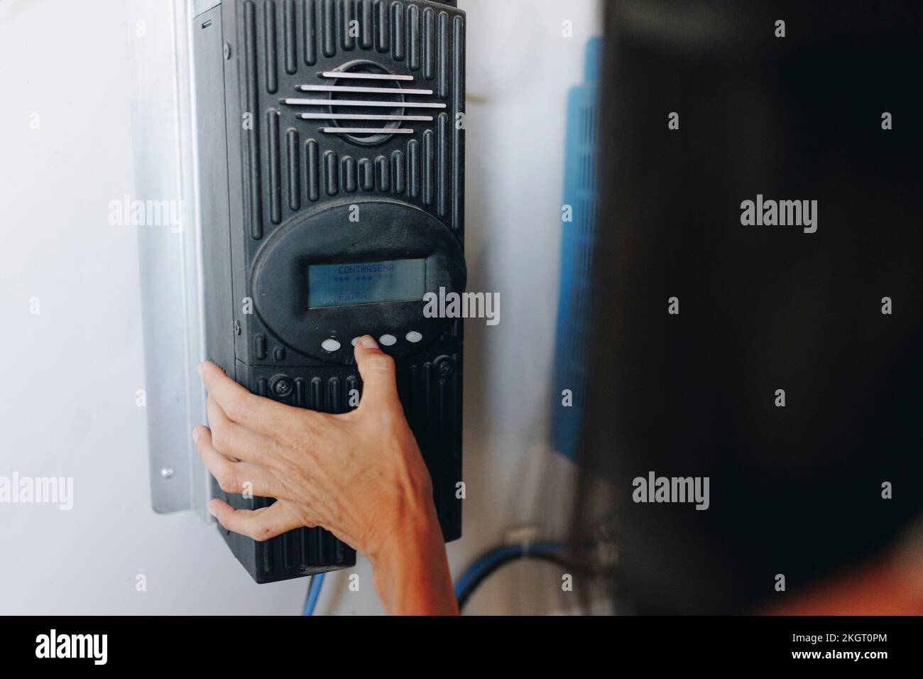 Hands of woman using solar charge controller Stock Photo