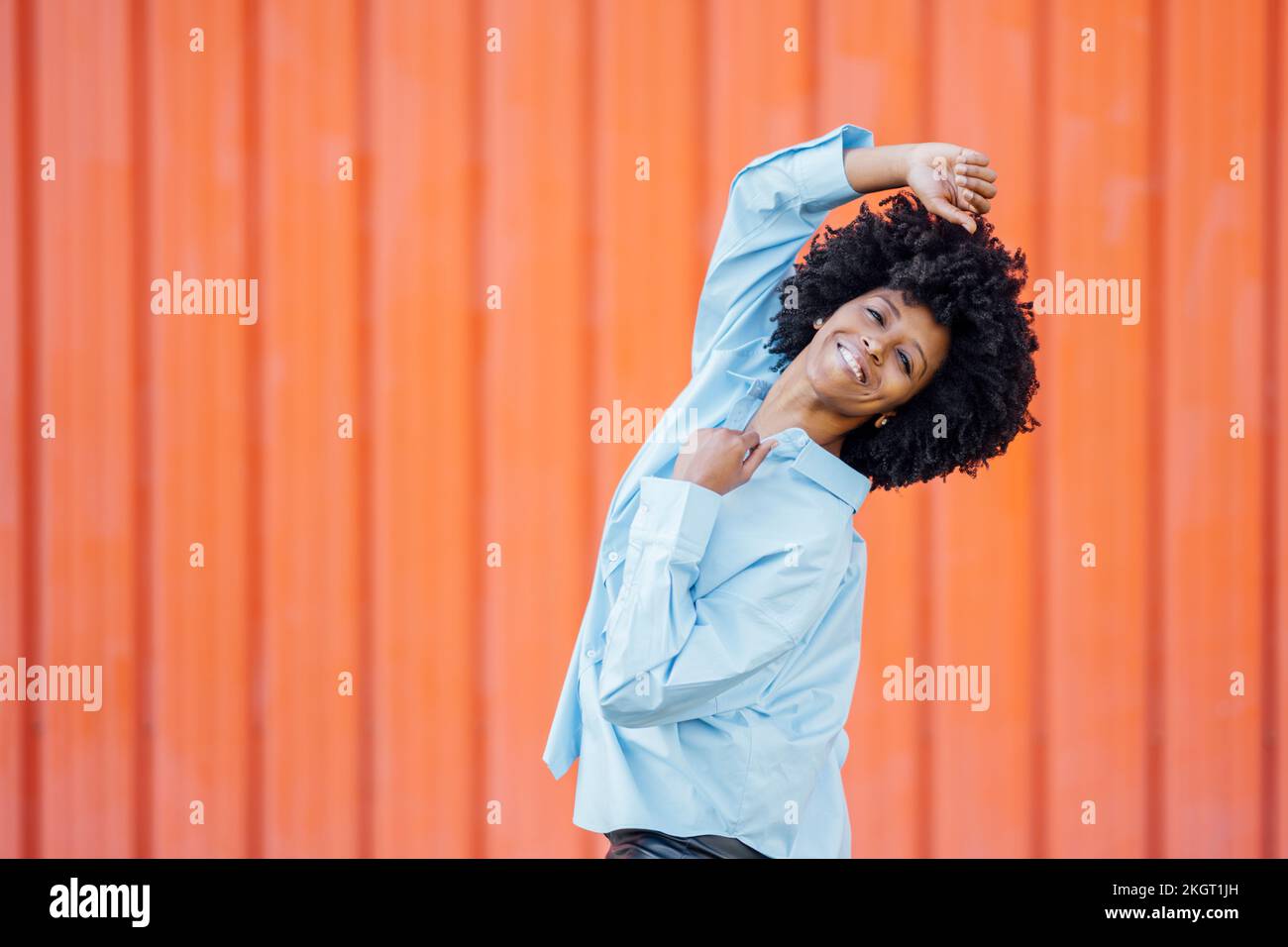 Young woman dancing outdoors orange hi-res stock photography and images ...