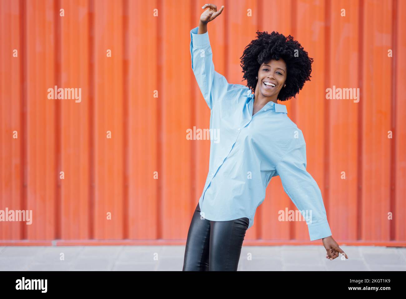 Young woman dancing outdoors orange hi-res stock photography and images ...