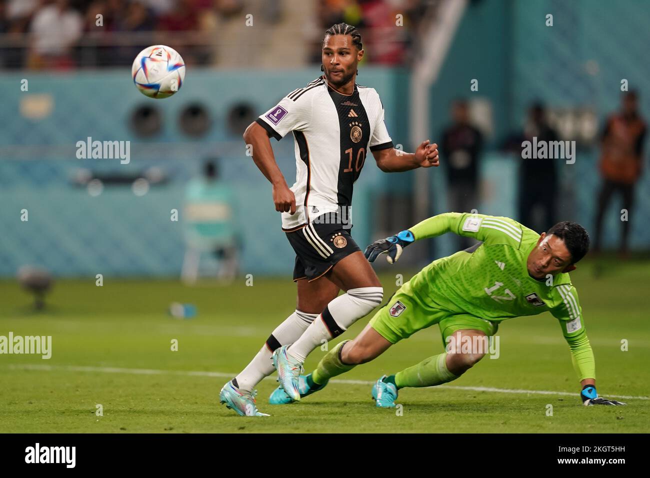 Doha, Qatar. 23rd Nov, 2022. DOHA, QATAR - NOVEMBER 23: Player of Japan Shuichi Gonda saves the ball whilst under pressure from Serge Gnabry of Germany during the FIFA World Cup Qatar 2022 group E match between Germany and Japan at Khalifa International Stadium on November 23, 2022 in Doha, Qatar. (Photo by Florencia Tan Jun/PxImages) Credit: Px Images/Alamy Live News Stock Photo