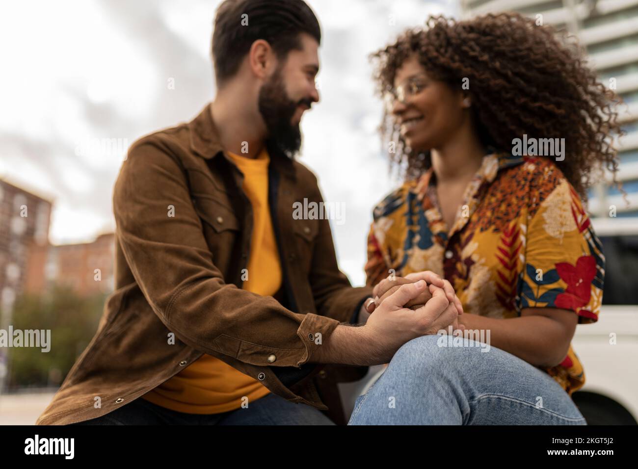 Happy boyfriend holding hands of girlfriend Stock Photo - Alamy