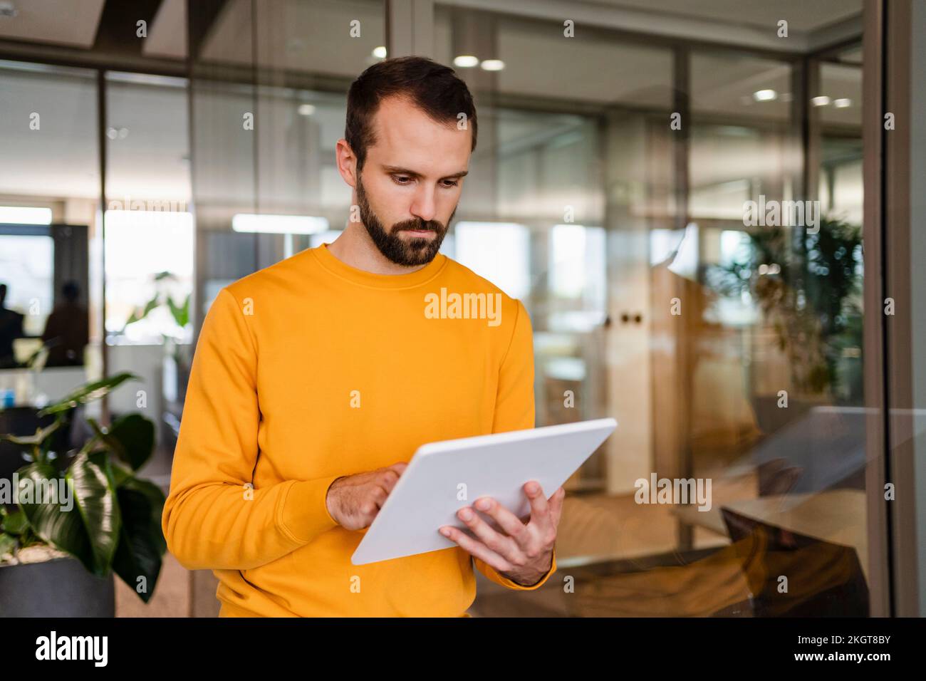 Young businessman using tablet PC in workplace Stock Photo