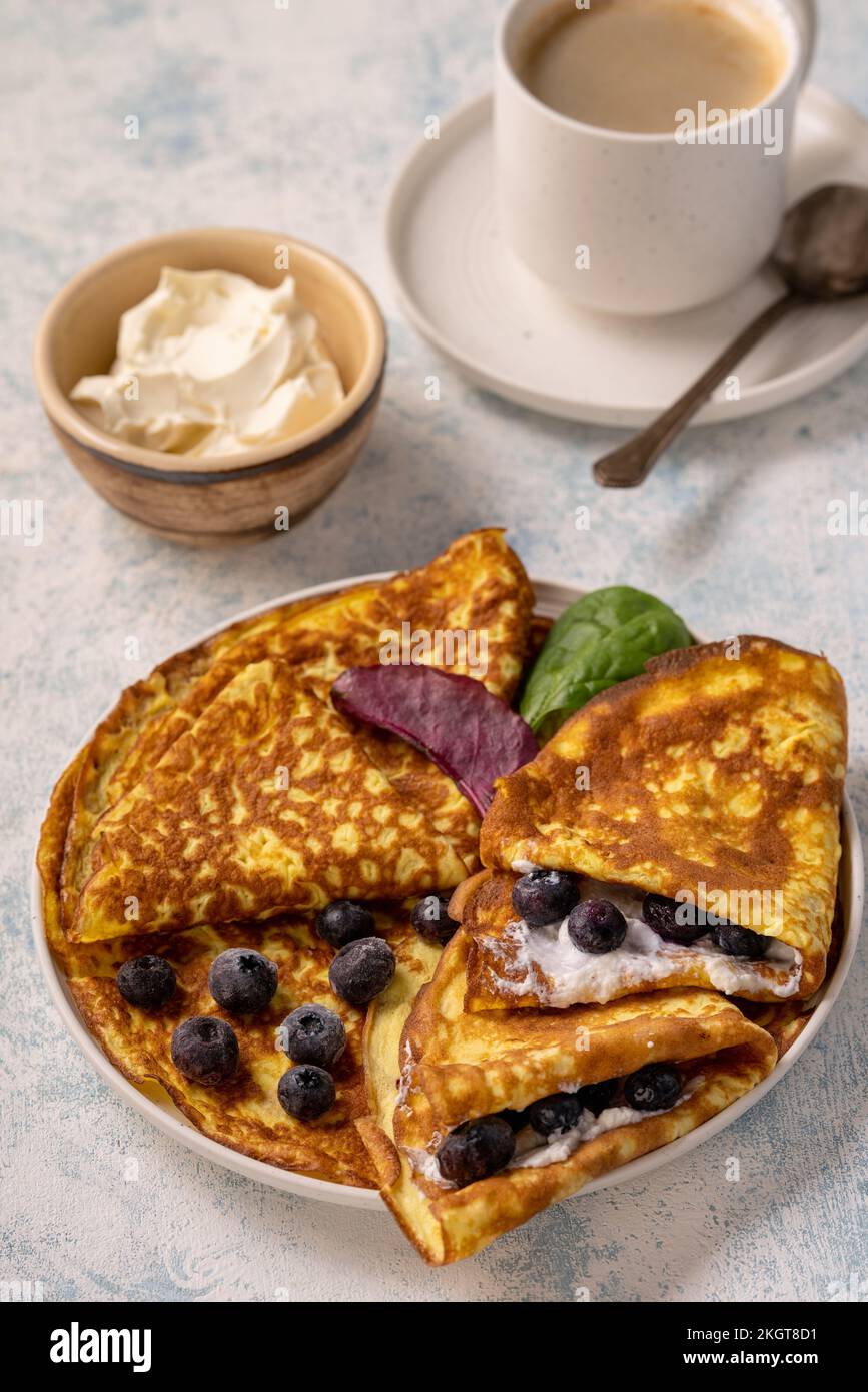Keto lunch keto pancakes served with ricotta and blueberries Stock