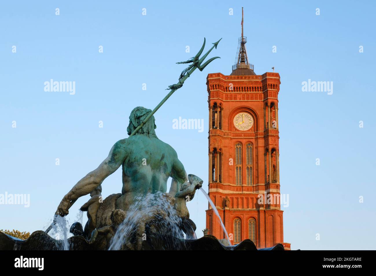 Germany, Berlin, Clock tower of Berlin Town Hall with Neptunbrunnen in foreground Stock Photo