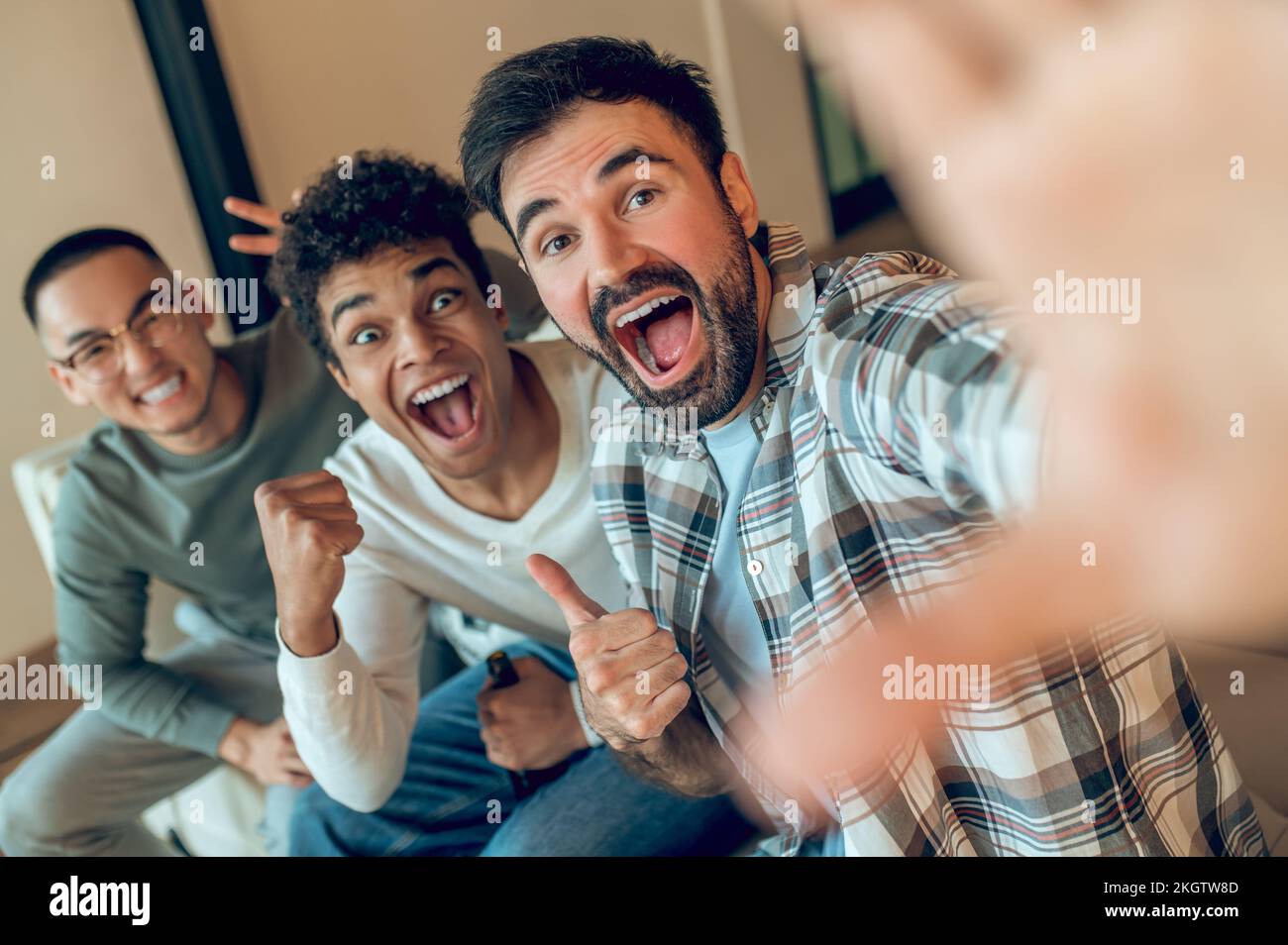 Merry friends photographing themselves with the smartphone Stock Photo