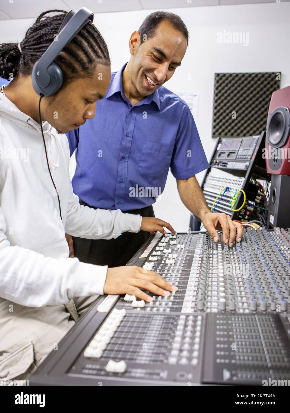 Music Students: Audio Mixer. A young sound engineer learning to use a ...