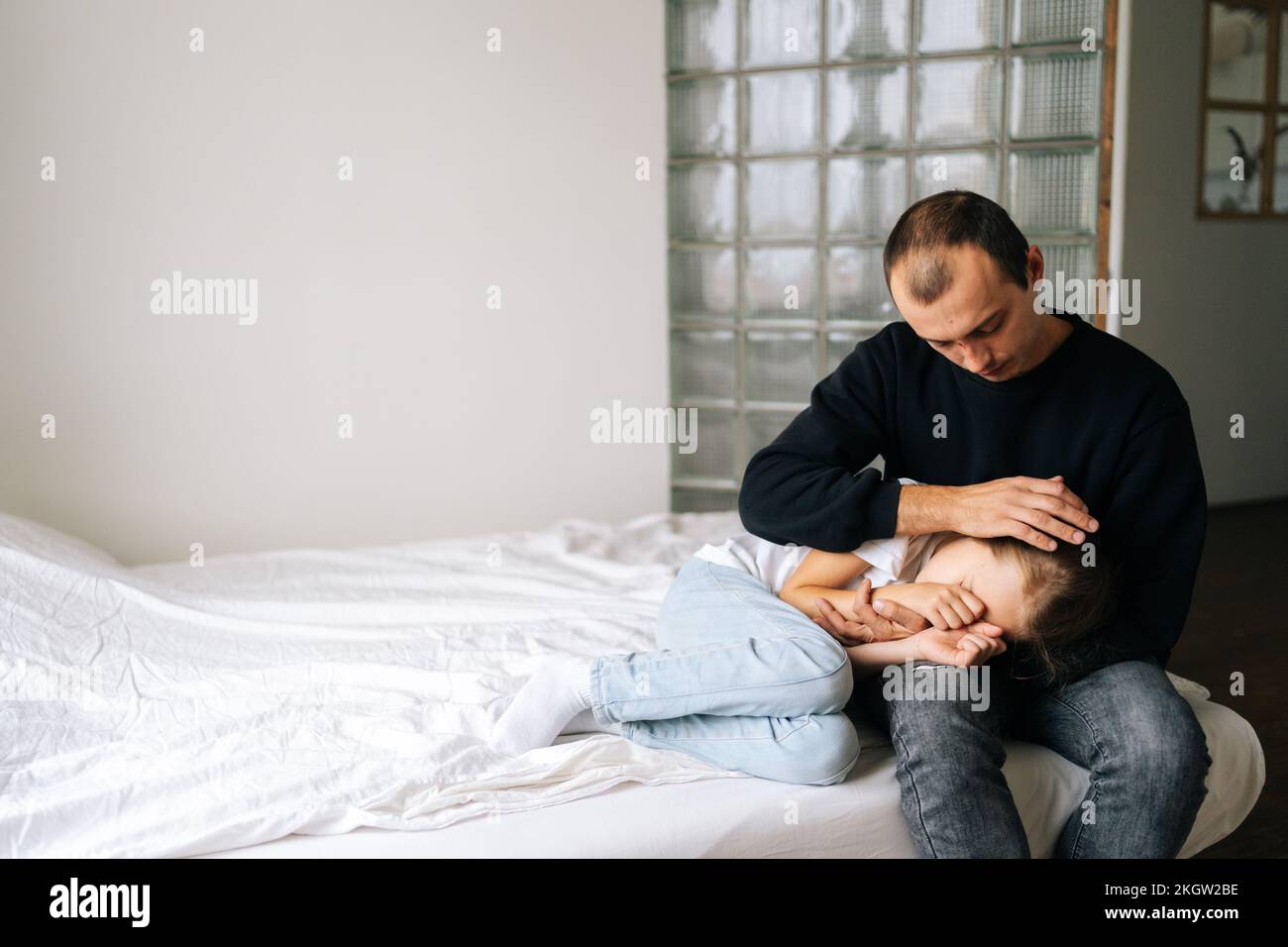 Portrait of loving caring father comforting offended sad little ...