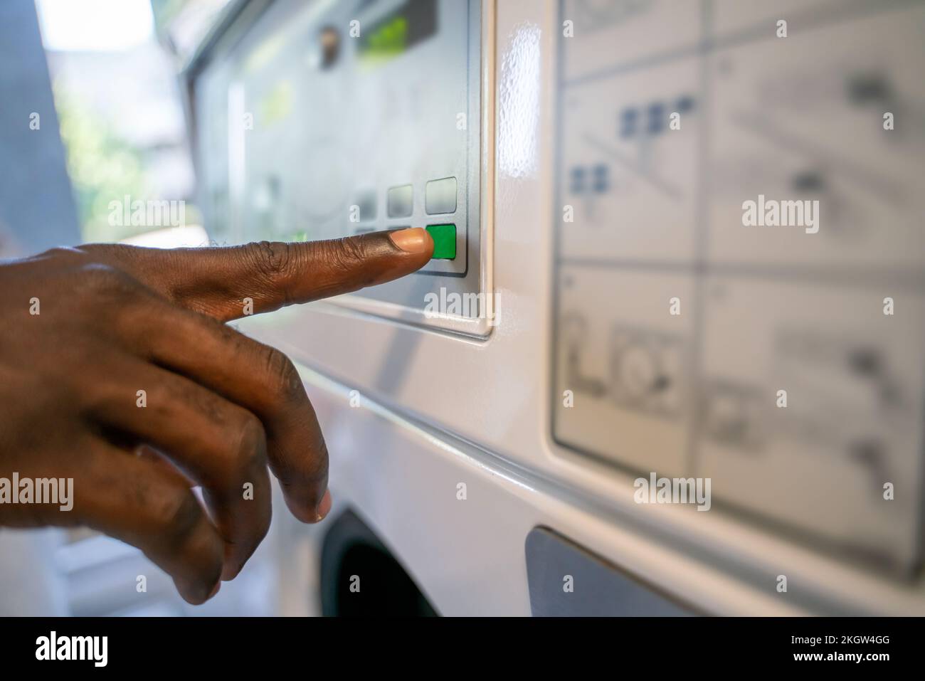 Person choosing the settings on a clothes washer Stock Photo