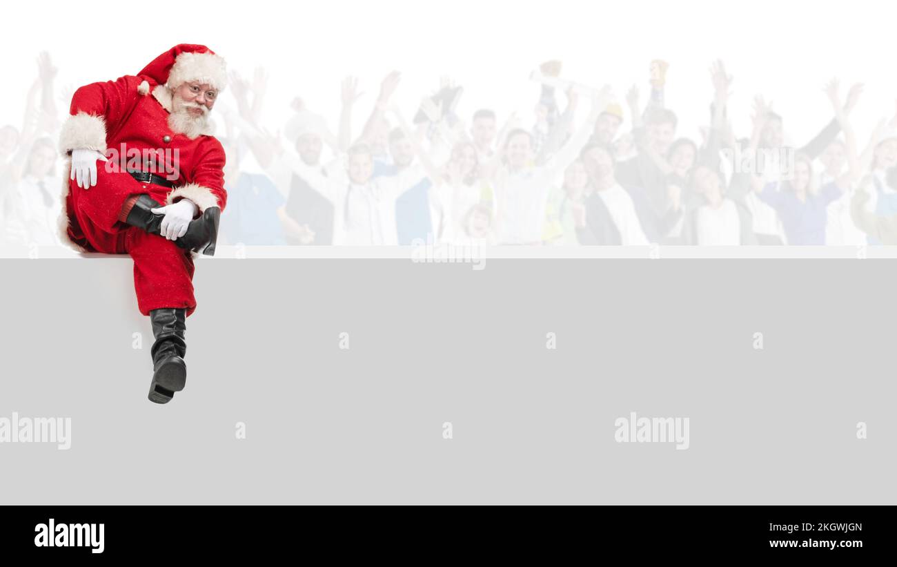 Santa Claus sitting on a blank panel isolated on white , many happy ...