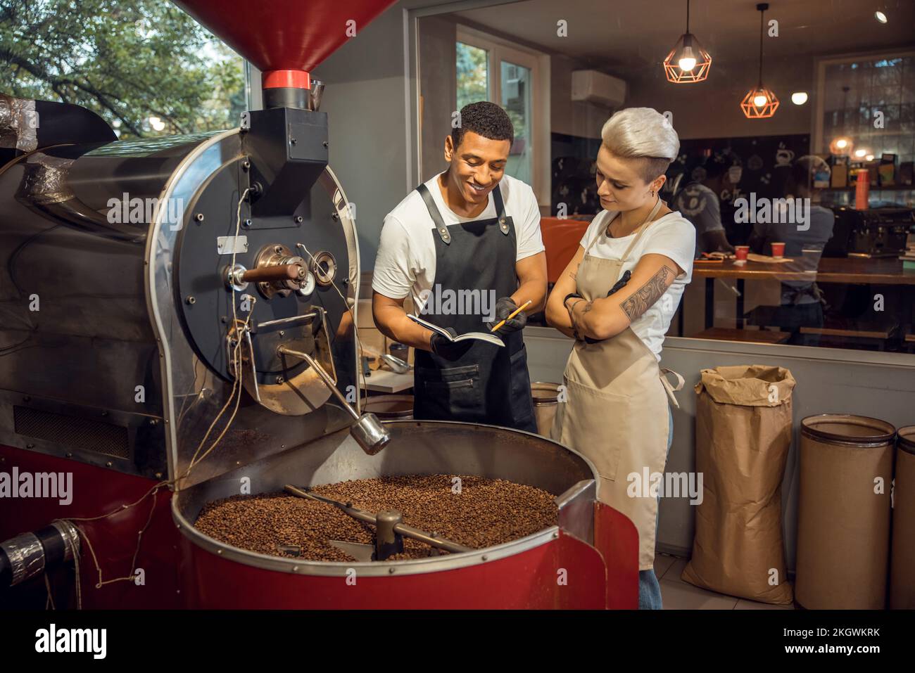 Two young roast masters engaged in work Stock Photo